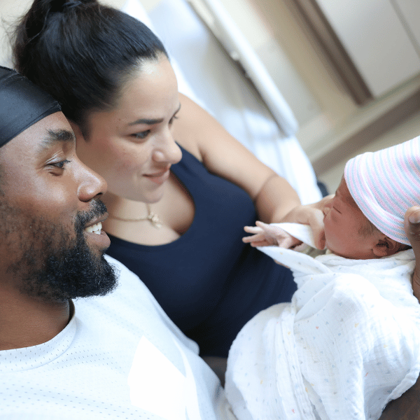 Young parents holding newborn baby