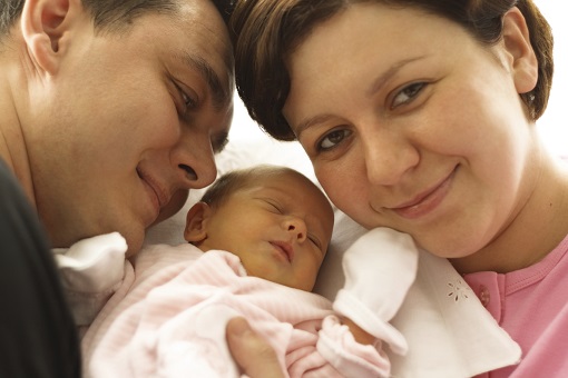 Latino mother and father with infant